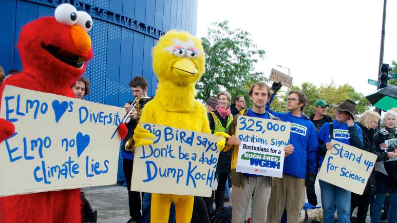 Protestors dressed as Elmo and Big Bird call on WGBH in Boston to cut ties with Koch Industries